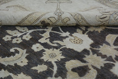A handmade Afghan Chobi rug featuring a floral pattern in cream and dark brown wool.