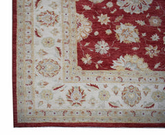 A handwoven Afghan Chobi rug featuring a red field with floral patterns and a cream border.