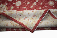 A handwoven Afghan Chobi rug featuring a red field with floral patterns and a cream border.