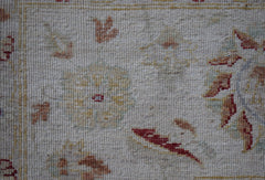 A close-up of an Afghan Chobi rug featuring traditional floral patterns in earthy tones.