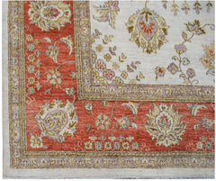 A handmade Afghan Chobi rug featuring a traditional floral pattern in rust, cream, and beige tones.
