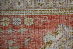 A close-up of a handwoven Afghan Chobi rug featuring traditional floral patterns in earthy tones.