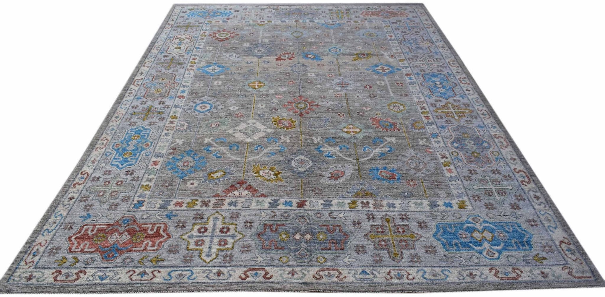A handwoven Afghan Chobi rug featuring a grey field with colorful traditional geometric patterns.
