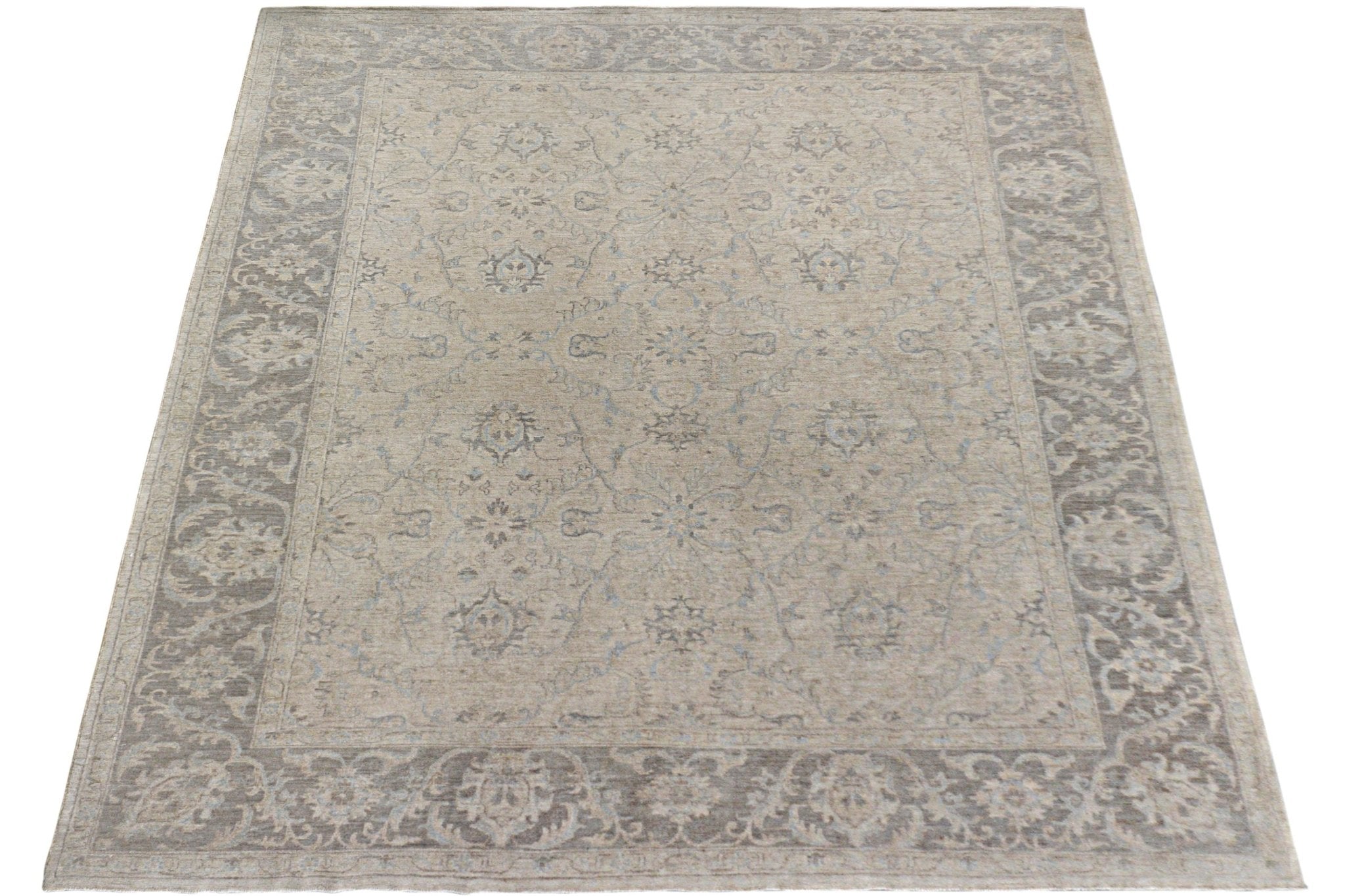 A handmade Afghan Chobi rug featuring a traditional floral pattern in neutral beige and grey tones.
