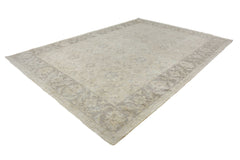 An Afghan Chobi rug featuring a traditional floral pattern in neutral beige and grey tones.