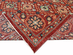 A handmade Afghan Chobi rug featuring a traditional floral pattern in warm red and blue tones.