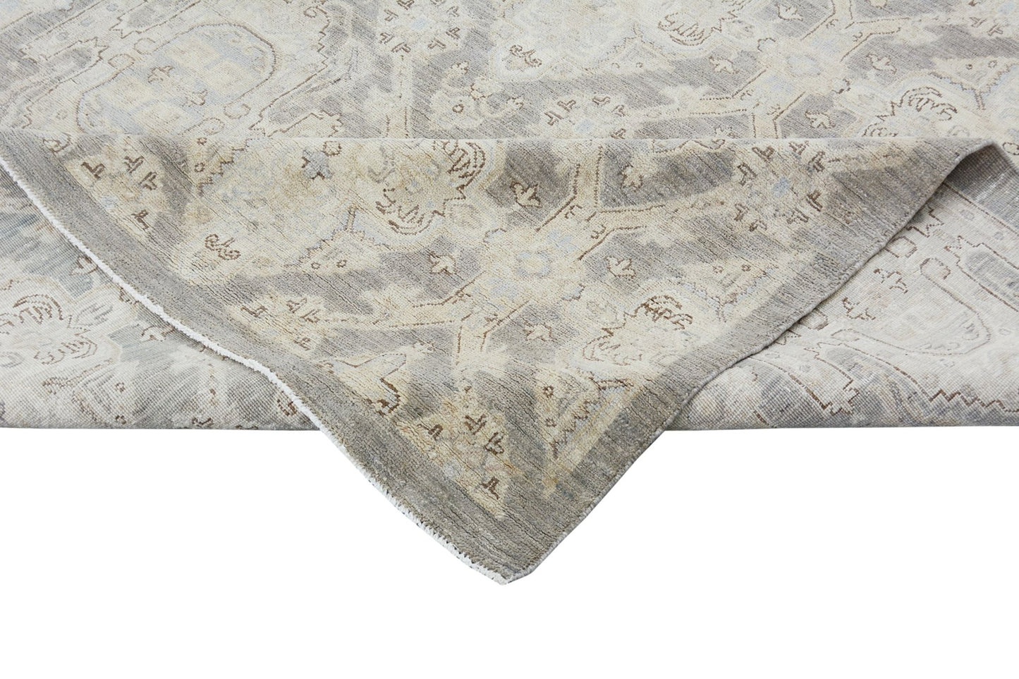 A handmade Afghan Chobi rug featuring a traditional pattern in neutral beige and grey tones.