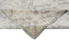 A handmade Afghan Chobi rug featuring a traditional pattern in neutral beige and grey tones.