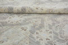 A handmade Afghan Chobi rug featuring a traditional pattern in neutral beige and grey tones.