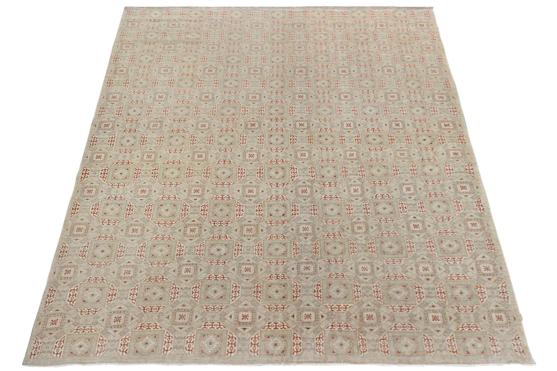 An Afghan Chobi rug featuring a repeating geometric pattern in soft earth tones.
