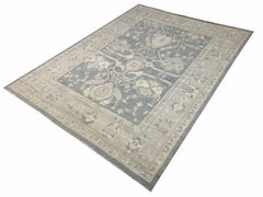 An Afghan Chobi rug featuring a traditional floral pattern in shades of blue and beige.
