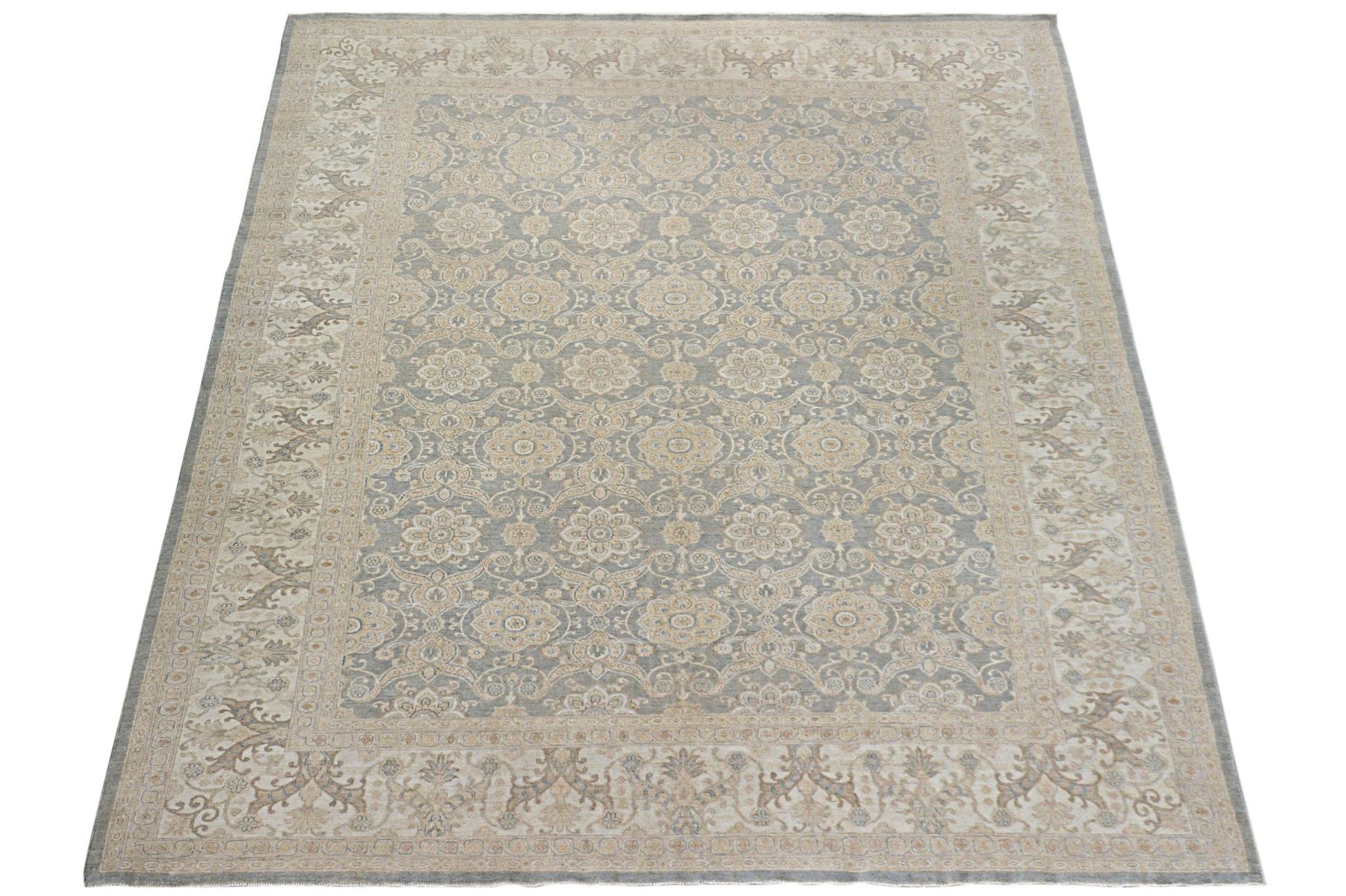 A handmade Afghan Chobi rug featuring a traditional floral pattern in soft grey and beige tones.