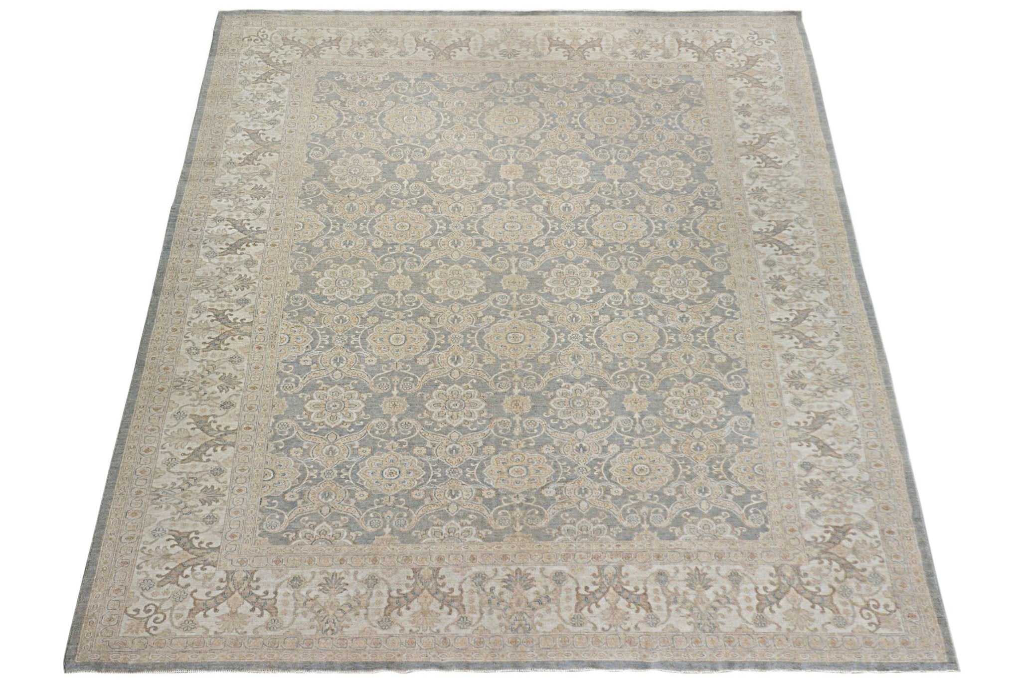 A handmade Afghan Chobi rug featuring a traditional floral pattern in soft grey and beige tones.