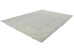 An Afghan Chobi rug featuring a traditional floral pattern in soft blue and beige tones.