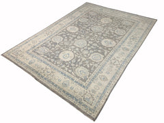 An Afghan Chobi rug featuring a traditional floral pattern in shades of grey, beige, and blue.