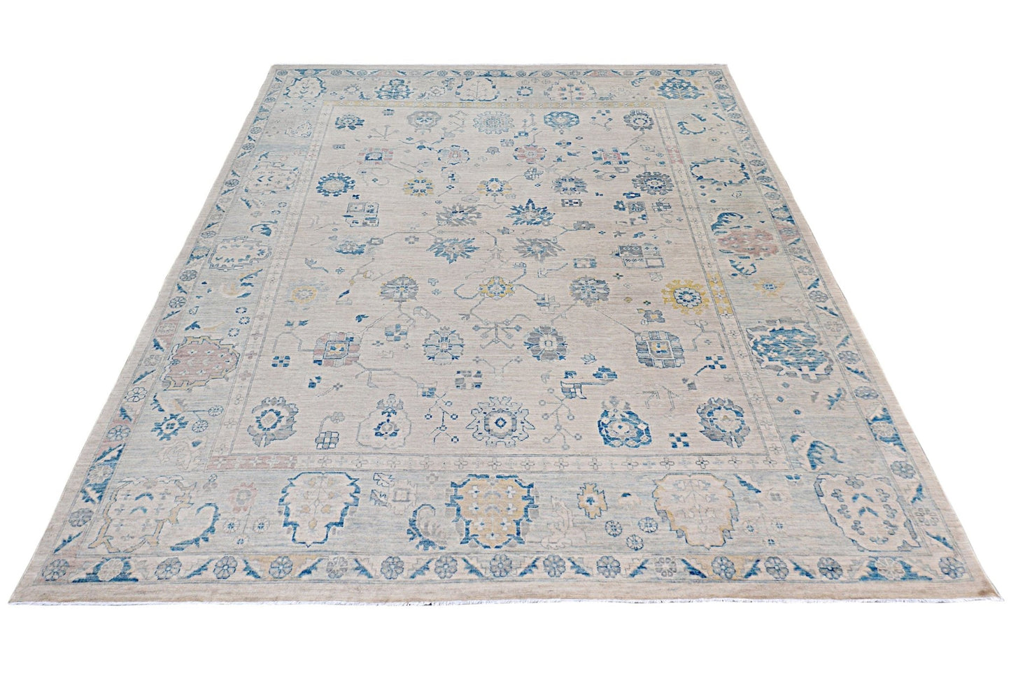 An Afghan Chobi rug featuring a traditional floral pattern in blue and beige tones.