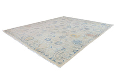 An Afghan Chobi rug featuring a traditional floral pattern in muted blue and beige tones.