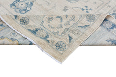 A handmade Afghan Chobi rug featuring a traditional floral pattern in blue on a cream background.