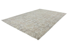 An Afghan Chobi rug featuring a traditional floral pattern in neutral beige and brown tones.
