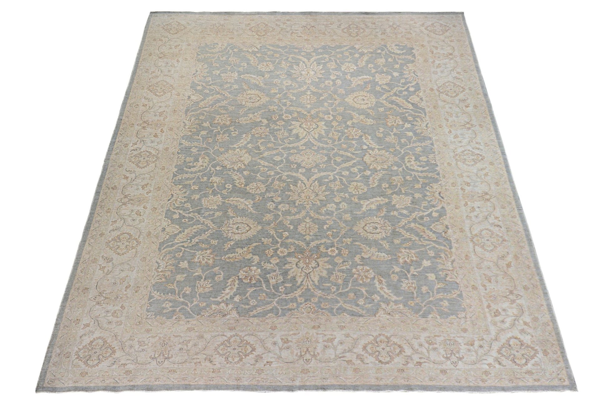 A handmade Afghan Chobi rug featuring a traditional floral pattern in soft blue and beige tones.