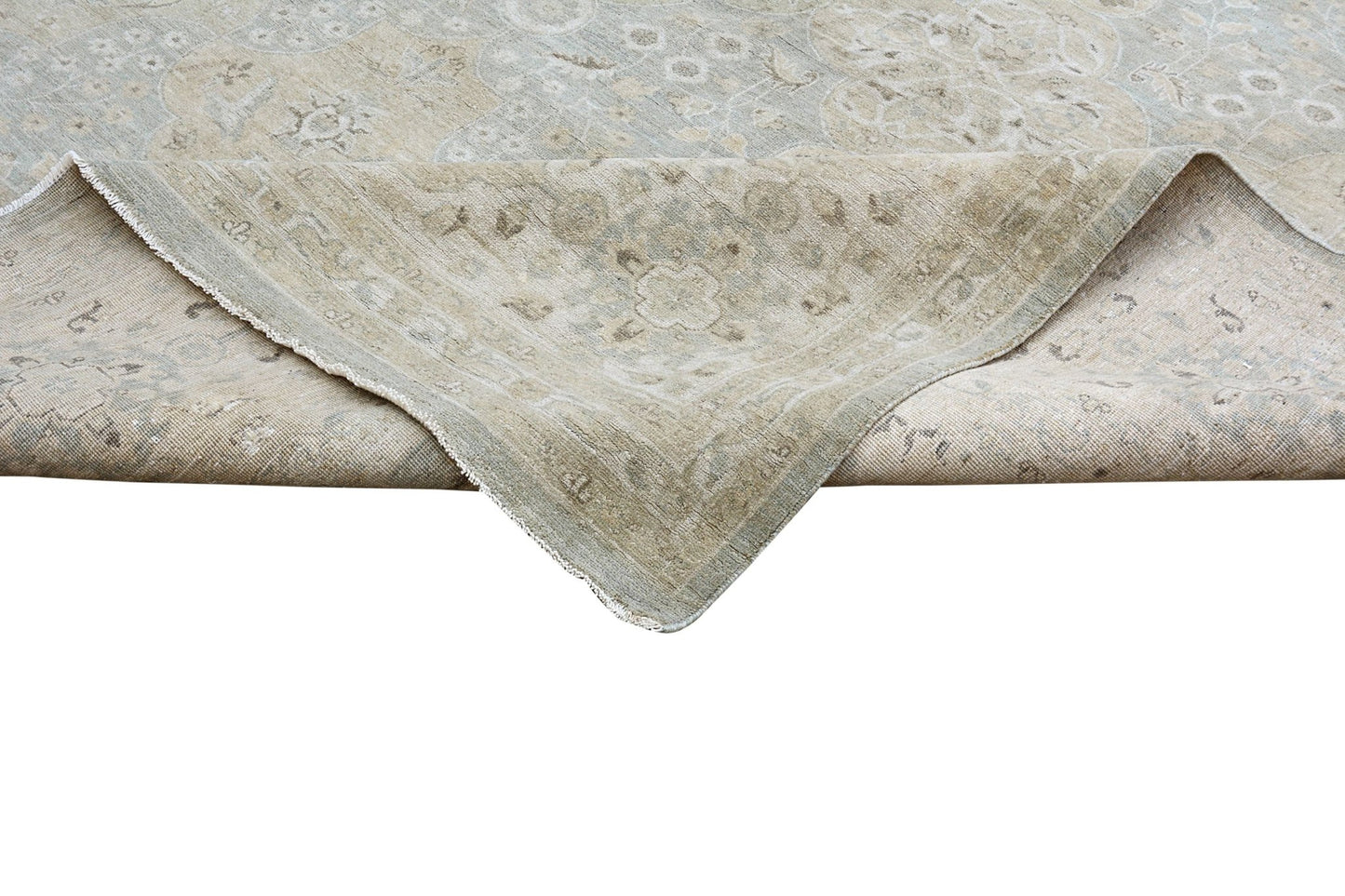 A handmade Afghan Chobi rug featuring a traditional floral pattern in soft beige and blue tones.
