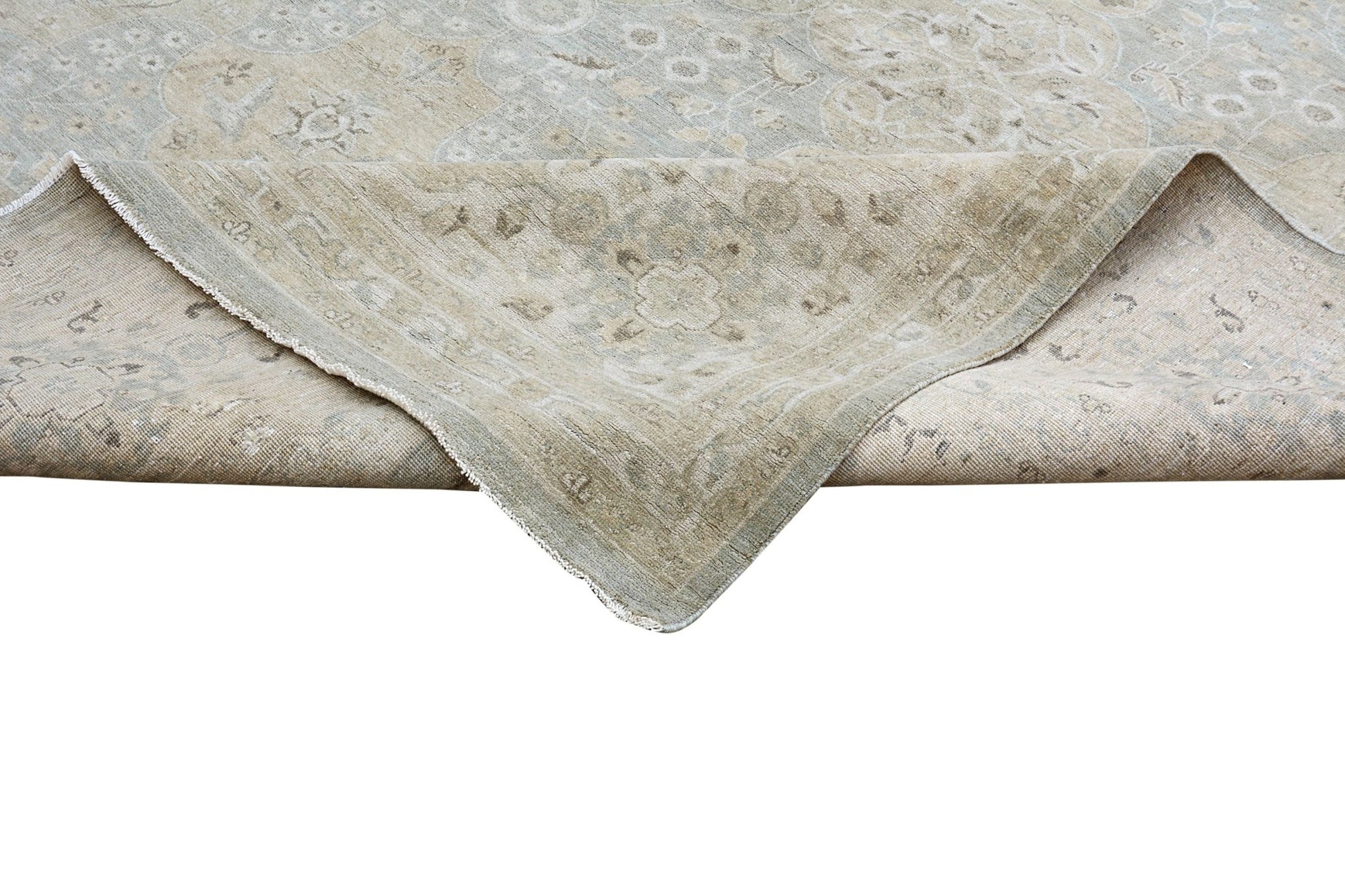 A handmade Afghan Chobi rug featuring a traditional floral pattern in soft beige and blue tones.