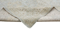 A handmade Afghan Chobi rug featuring a traditional floral pattern in soft beige and blue tones.