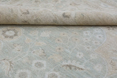 A handmade Afghan Chobi rug featuring a traditional floral pattern in soft beige and blue tones.