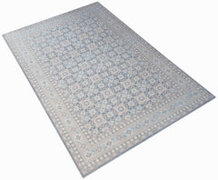 A rectangular Afghan Chobi rug featuring a traditional geometric pattern in muted blue and beige.