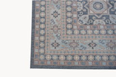 A handwoven Afghan Chobi rug featuring a traditional geometric pattern in blue and beige tones.