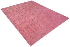 An overdyed Afghan Chobi rug featuring a faded floral pattern in shades of pink.