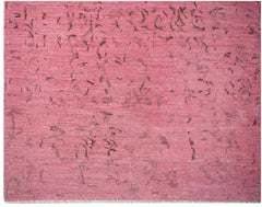 An overdyed Afghan Chobi rug featuring a distressed pink field with subtle dark brown patterns.