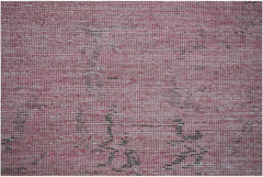 A close-up of a handwoven Afghan Chobi rug featuring a textured pink and brown overdyed pattern.