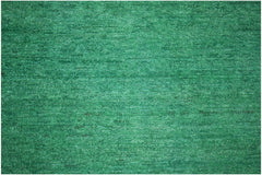 A handmade Afghan Chobi rug featuring a vibrant, overdyed solid green wool texture.