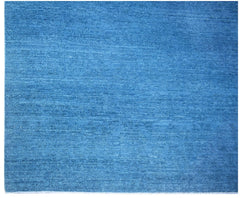 A handwoven Afghan Chobi rug featuring a solid, textured blue wool surface.
