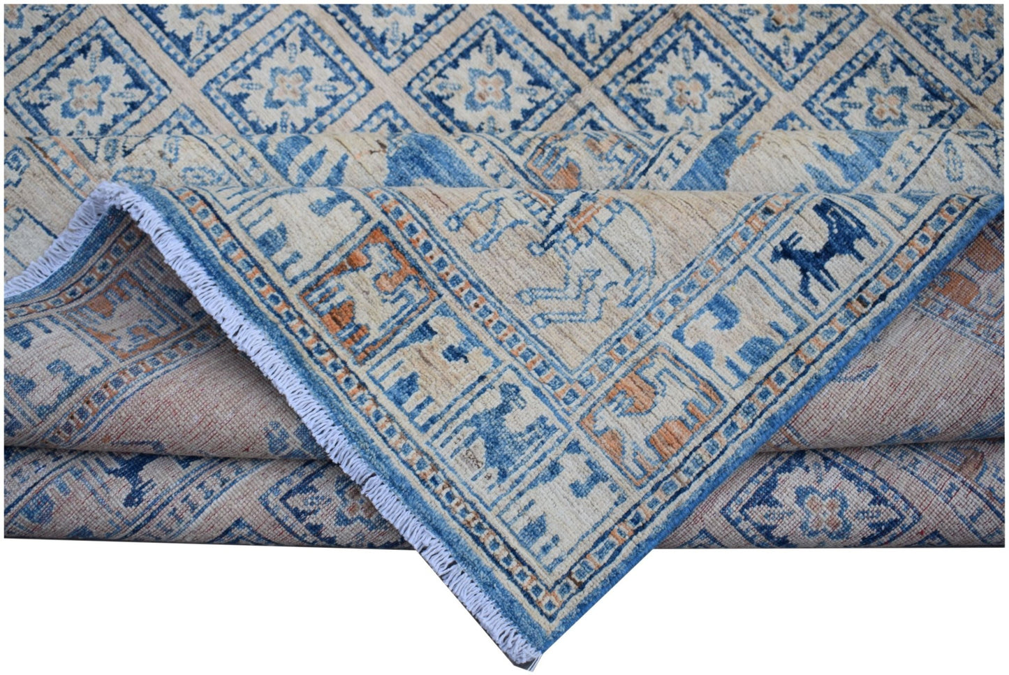 A handmade Afghan Chobi rug featuring a blue and cream geometric Pazyryk pattern.