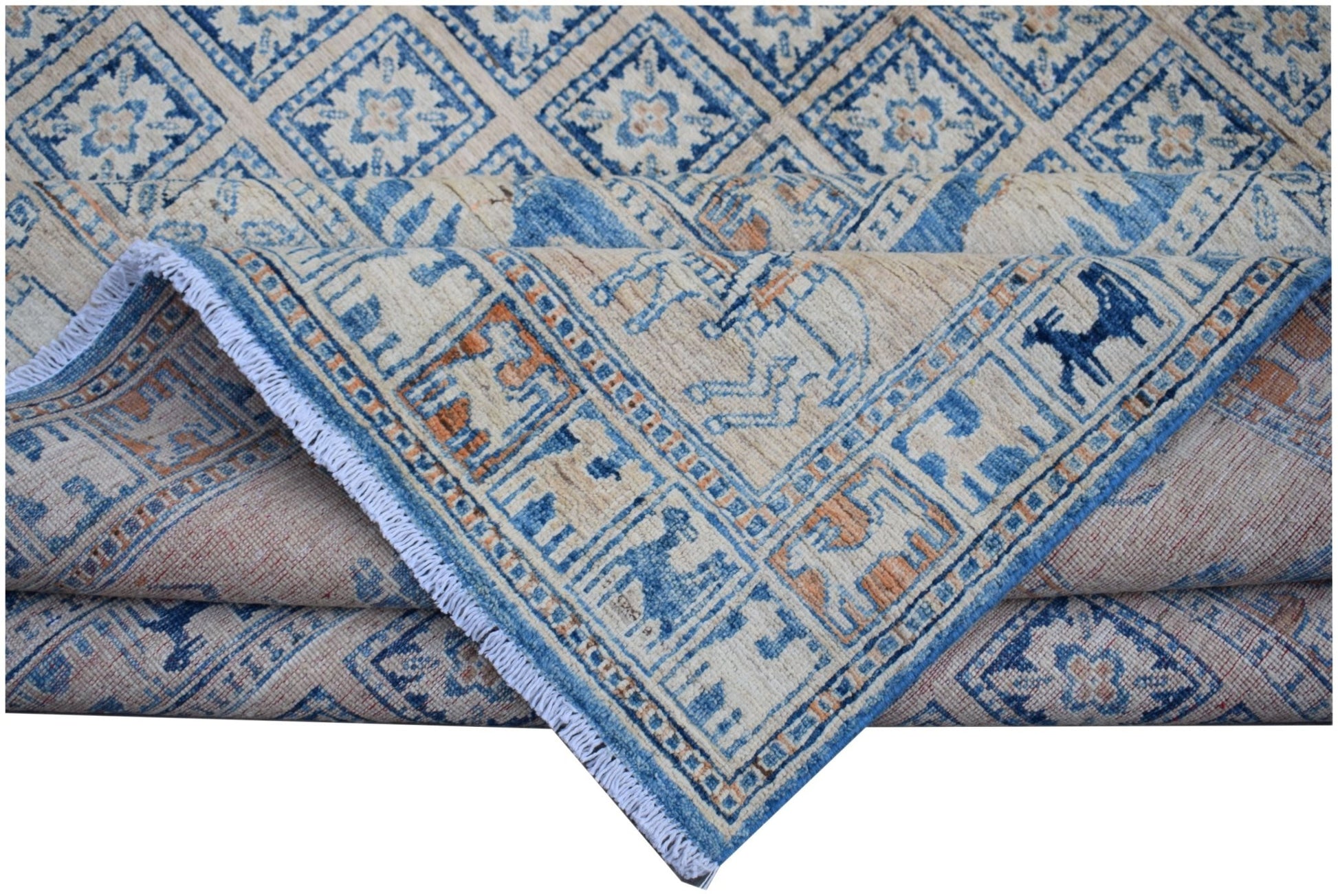 A handmade Afghan Chobi rug featuring a blue and cream geometric Pazyryk pattern.