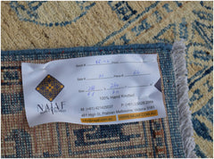 A close-up view of the back of a handmade Afghan Chobi rug with a product information label.
