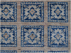 Handmade Afghan Chobi rug featuring a repeating blue and beige geometric floral pattern.