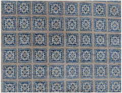 Handmade Afghan Chobi rug featuring a repeating grid of blue and beige floral square motifs.