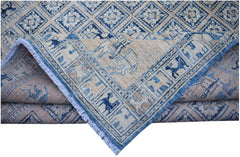 A handmade Afghan Chobi rug featuring a blue and beige geometric Pazyryk pattern with fringe.