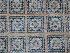 Handmade Afghan Chobi rug featuring a repeating grid of blue and beige floral geometric motifs.