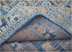A handmade Afghan Chobi rug featuring a blue and beige geometric pattern with a folded corner.