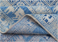 A blue and cream Afghan Chobi rug with traditional Pazyryk geometric patterns.