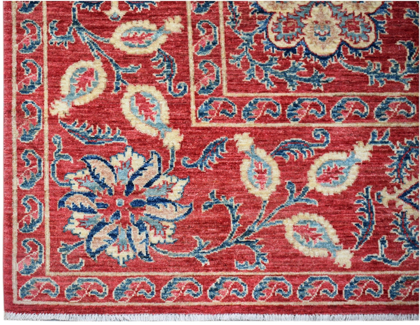 Handwoven Afghan Chobi rug featuring traditional Suzani floral motifs in red, blue, and cream.