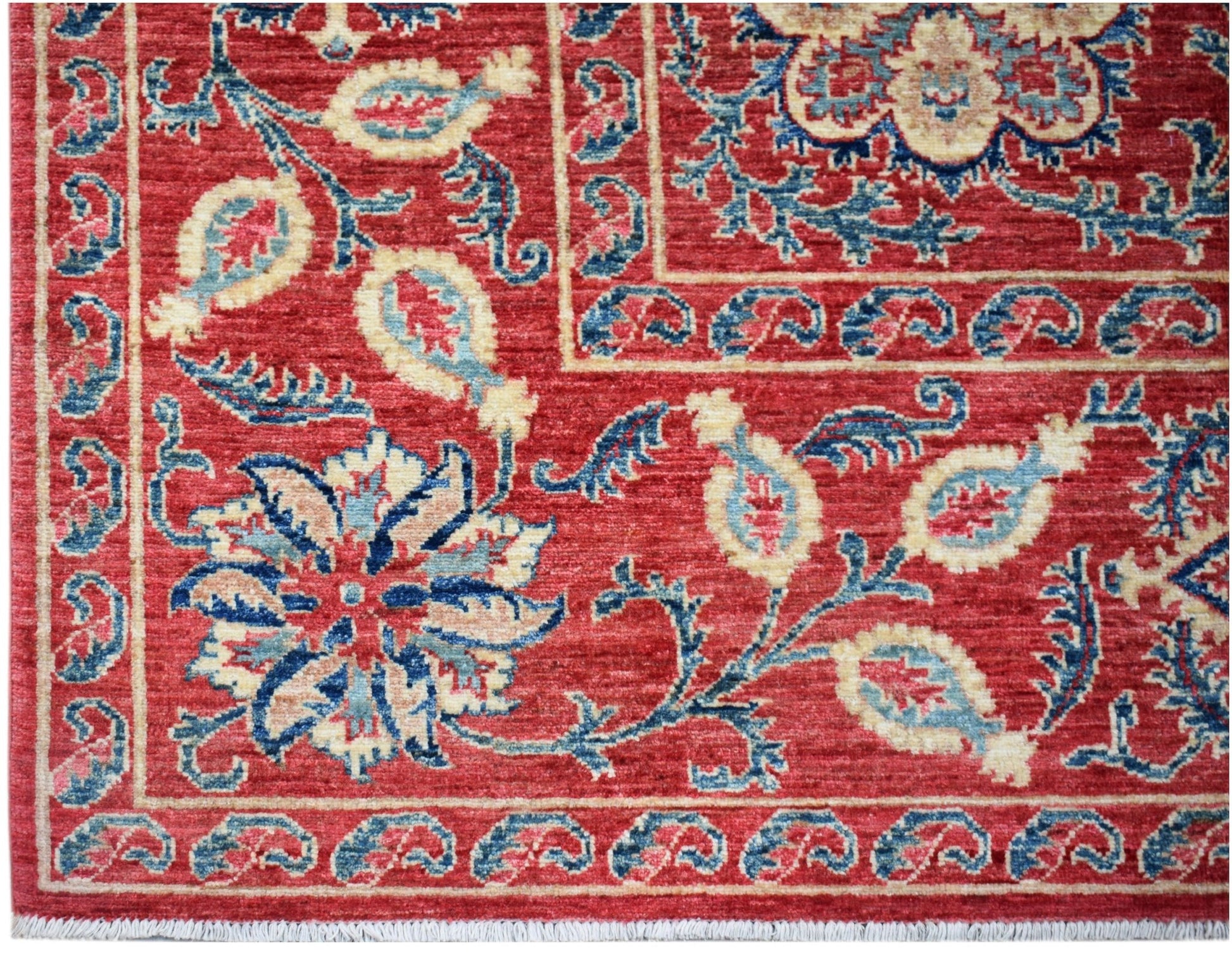 Handwoven Afghan Chobi rug featuring traditional Suzani floral motifs in red, blue, and cream.