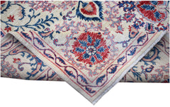A handmade Afghan Chobi rug featuring a traditional Suzani floral pattern in red and blue tones.