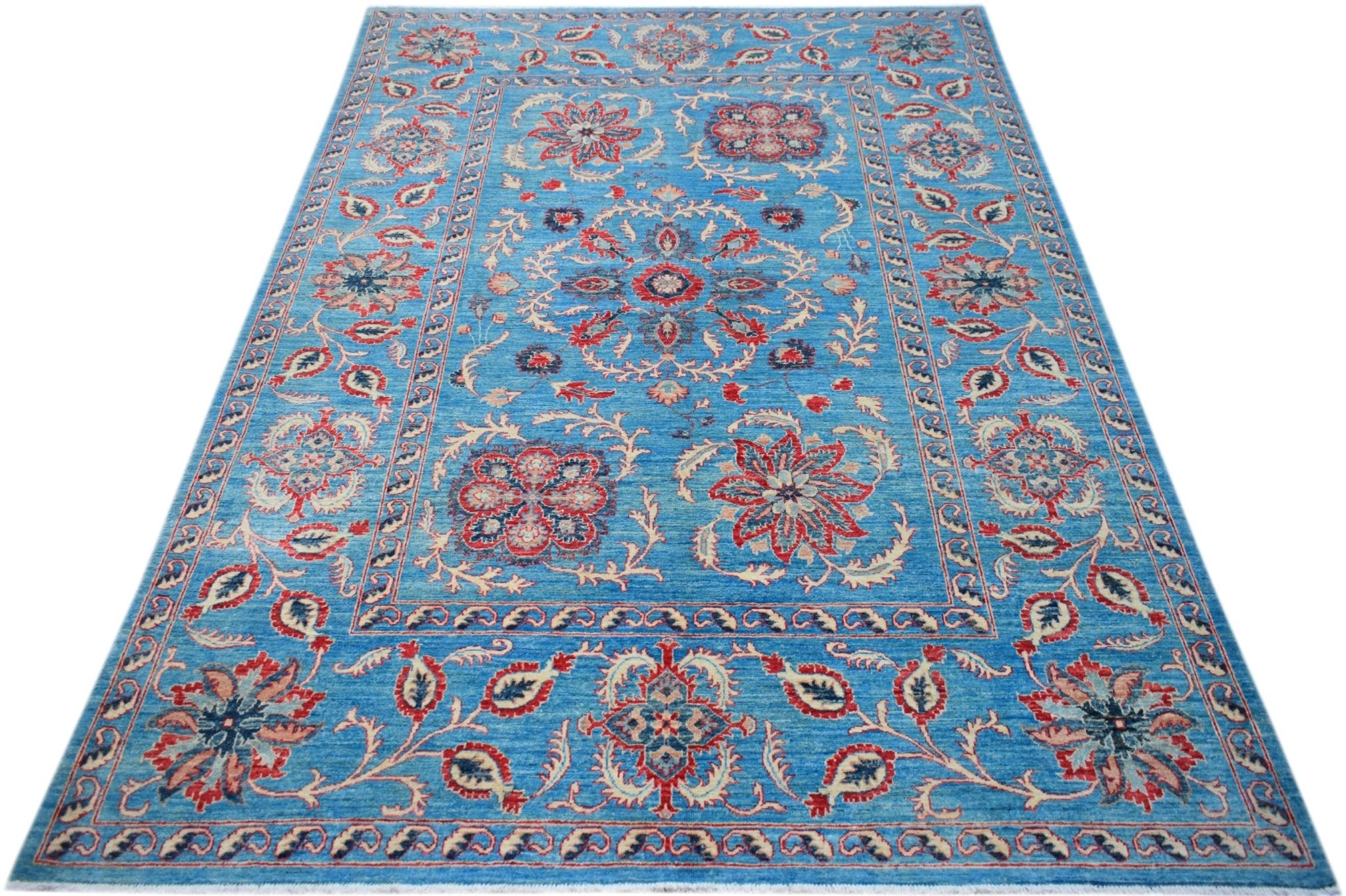 A rectangular Afghan Chobi rug featuring a blue field with intricate red and cream floral motifs.