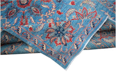 A handmade Afghan Chobi rug featuring a blue field with traditional red and cream floral motifs.