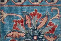 A close-up of a handwoven Afghan Chobi rug featuring a traditional blue floral Suzani pattern.